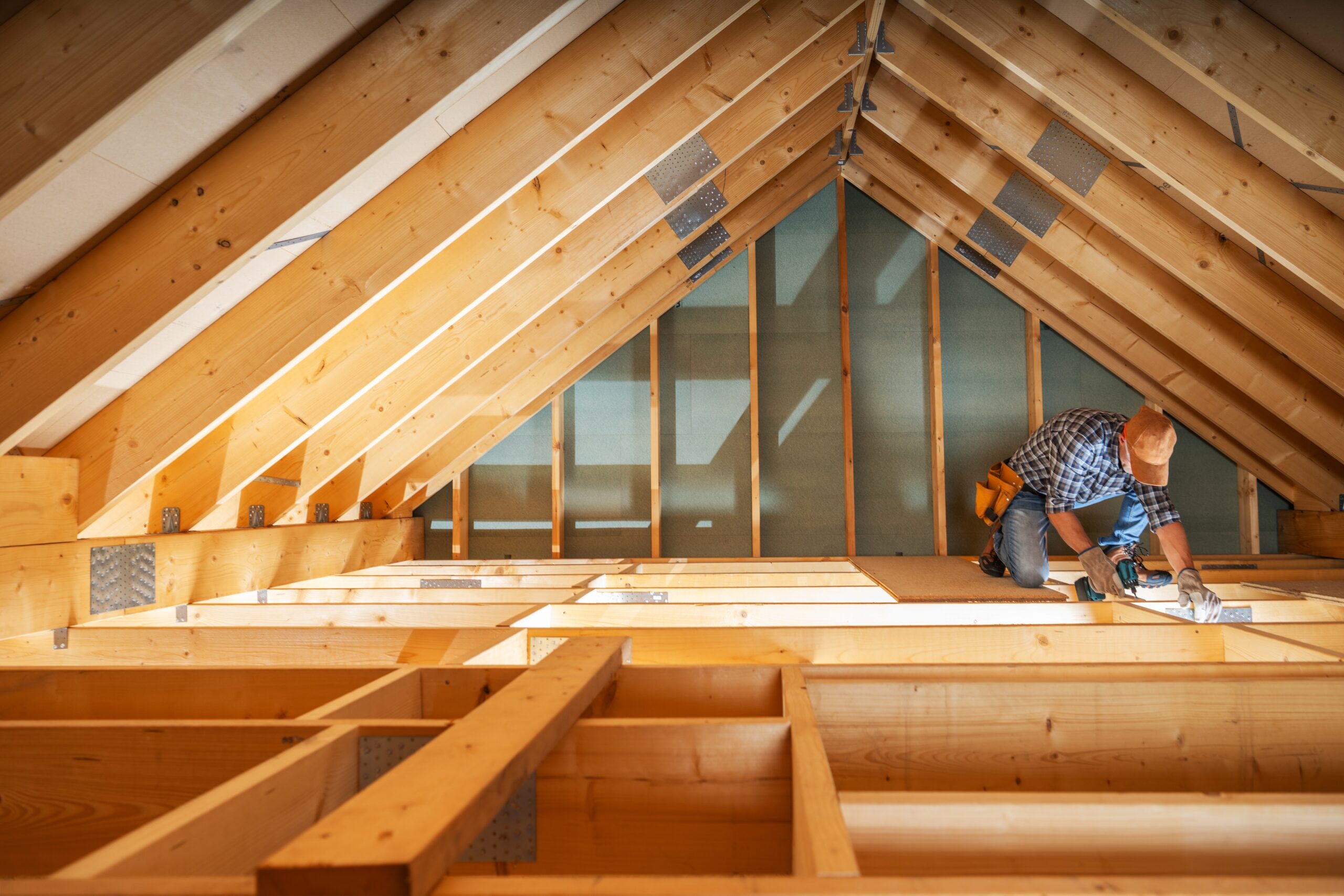 A,Carpenter,Carefully,Measures,And,Adjusts,Wooden,Beams,In,An